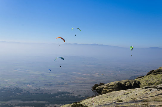 Paragliders at clear blue sky 