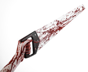 bloody hand holding a bloody saw on a white background