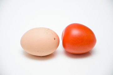 Egg and red tomato on a white background