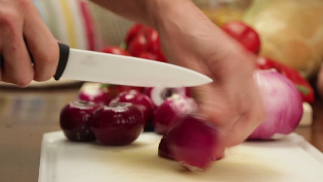 HD 1080 closeup: chef chopping red onions - closeup