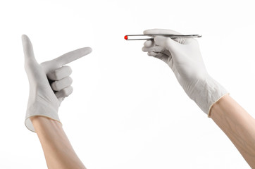 doctor's hand holding tweezers with red pill capsule isolated