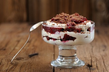 Rye bread tiramisu with cherries, chocolate and silver spoon on
