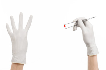 doctor's hand holding tweezers with red pill capsule isolated 