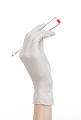 doctor's hand holding tweezers with red pill capsule isolated 