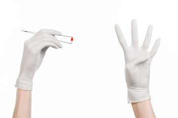 doctor's hand holding tweezers with red pill capsule isolated 