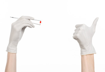 doctor's hand holding tweezers with red pill capsule isolated 