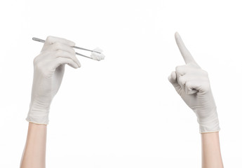 doctor's hand holding tweezers with swab isolated studio