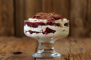 Rye bread tiramisu with cherries and chocolate on wooden backgro