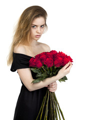 Portrait of a young beautiful girl with a bouquet of red roses
