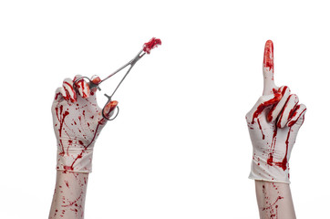 doctor bloody hand in glove holding a surgical clamp with swab