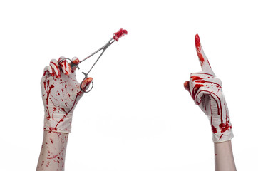 doctor bloody hand in glove holding a surgical clamp with swab