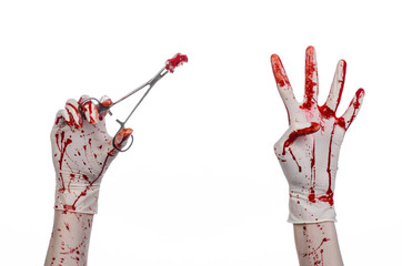 doctor bloody hand in glove holding a surgical clamp with swab