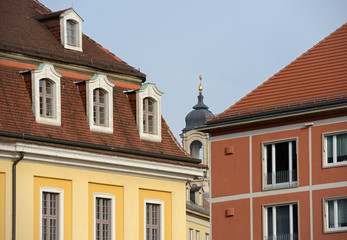 Fototapeta na wymiar Bell tower of Frauenkirche in gap between buildings in Dresden.