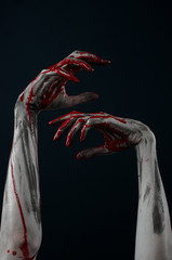 horrible zombie demon bloody hands on a black background
