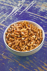 Walnut Kernels in Bowl on Rustic Wooden Background