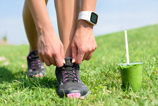 Running shoes sports smartwatch and green smoothie