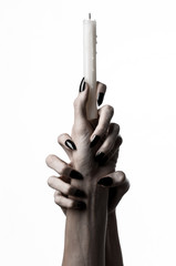 hands holding a candle, a candle is lit, white background