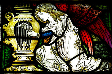 Angel making music in stained glass - obrazy, fototapety, plakaty
