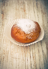 Vintage photo of one homemade donut on white table
