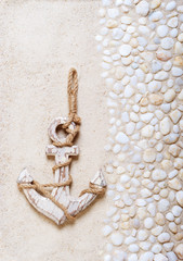 Decorative anchor on the sea sand