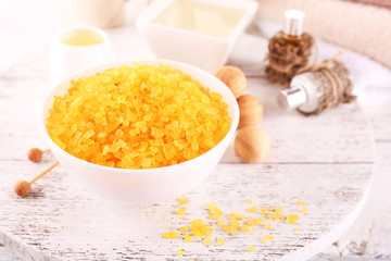 Spa still life with color sea salt on wooden table, closeup