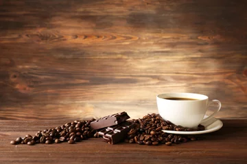 Poster Cup of coffee with grains on wooden background © Africa Studio
