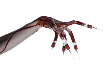 Bloody hand with syringe on the fingers, toes syringes in studio