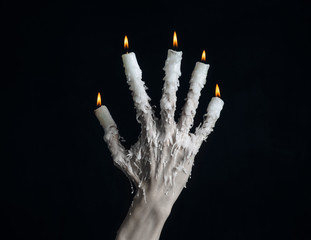 on the hand wearing a candle and dripping melted wax studio