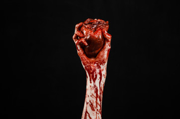 terrible bloody hand hold torn bleeding human heart isolated