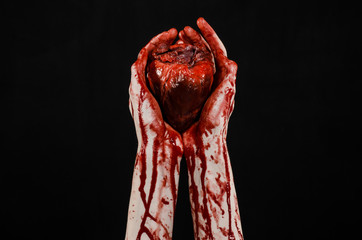 terrible bloody hand hold torn bleeding human heart isolated
