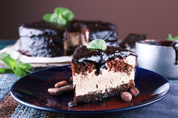 Delicious chocolate cake with icing in plate on table, closeup