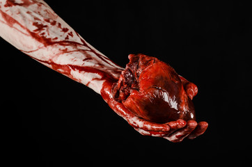 terrible bloody hand hold torn bleeding human heart isolated