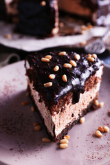 Delicious chocolate cake with icing in plate on table, closeup