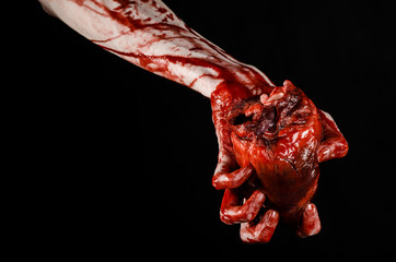 terrible bloody hand hold torn bleeding human heart isolated