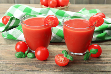 Glasses of tomato juice with vegetables on table close up