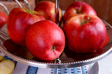 Tasty ripe apples on serving tray on table close up