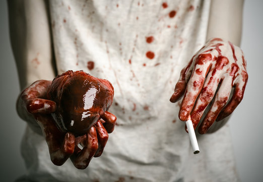 bloody hand holding a cigarette smoker and bloody human heart