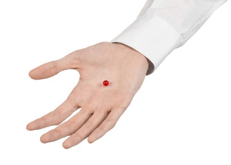 doctor's hand holding a red capsule for health isolated