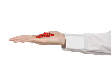 doctor's hand holding a red capsule for health isolated
