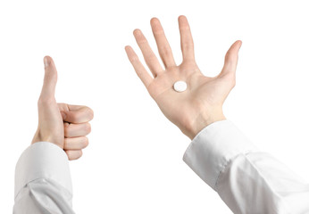 doctor's hand holding a white tablet for health  isolated