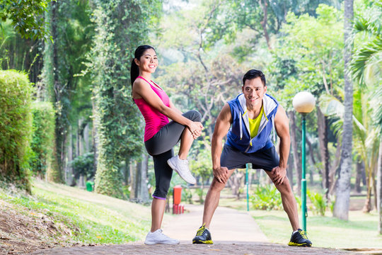 Asian Woman And Man Gymnastics Stretching