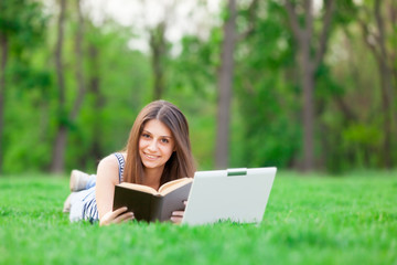 girl with laptop computer and book