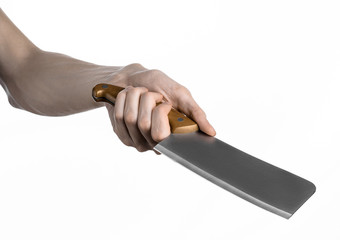 Hand holding a knife for meat, chef holding a kitchen knife