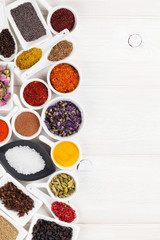 Various spices on white wooden background
