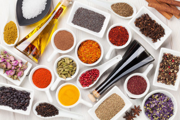 Various spices on white wooden background