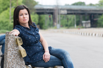 Female sitting and waiting train on the platform