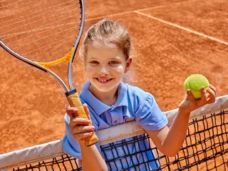Rolgordijnen Girl athlete  with racket and ball on  tennis court © Gennadiy Poznyakov