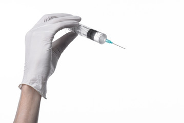 Doctor's hand holding a syringe, white-gloved hand