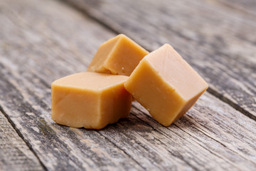Tasty toffees on wooden background.