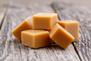 Tasty toffees on wooden background.